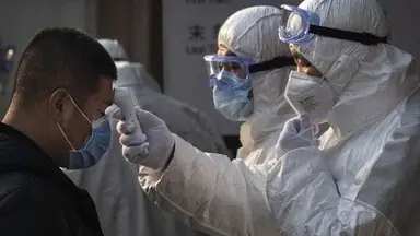 a_chinese_health_worker_checks_the_temperature_of_a_woman_entering_a_subway_station_during_the_chine_1582078124